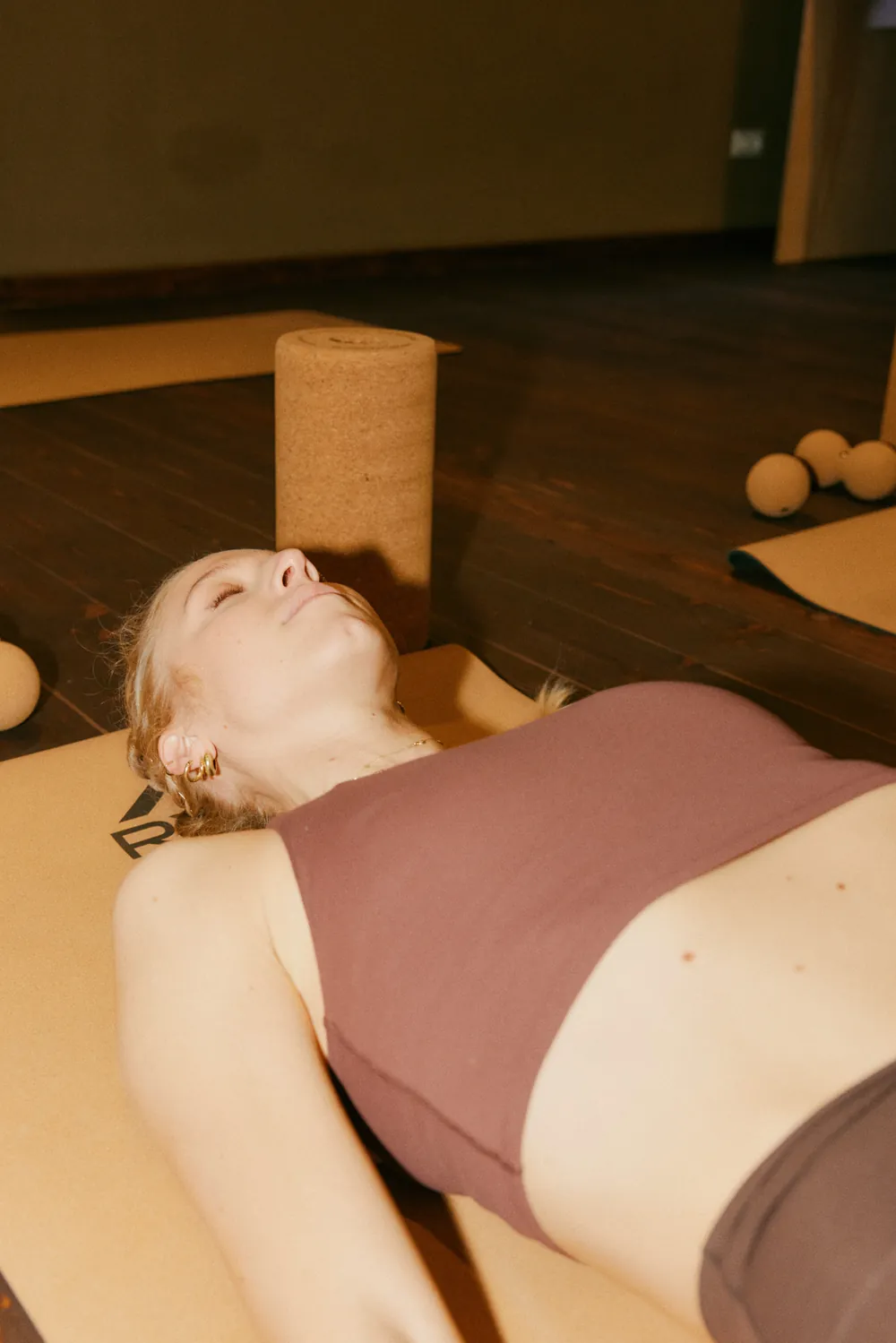 A participant lying on the mat with her eyes closed